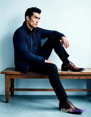 Bold flat-color wall art graphic of an Asian man with fair skin and black short hair styled back sit