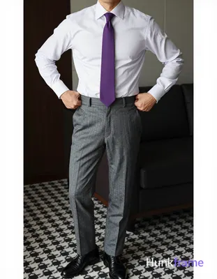 A handsome masculine man in a premium fashion editorial, standing with torso angled slightly right. 