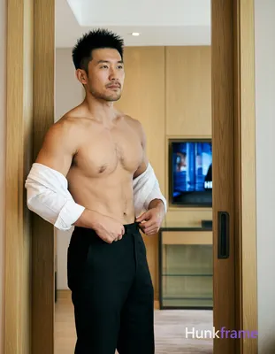 Asian man with short spiky black hair, light-medium skin tone, clean-shaven chin and upper lip with 