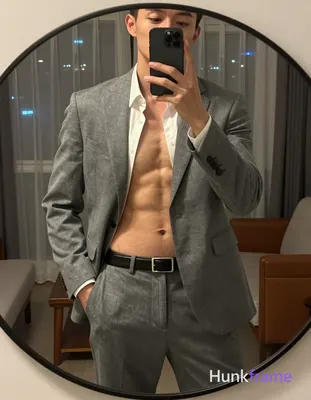 Shirtless adult man with defined abdominal musculature including rectus abdomini