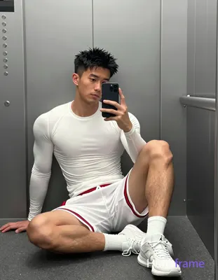 Polished anime style rendering of Asian man with short spiky black hair seated against gray elevator