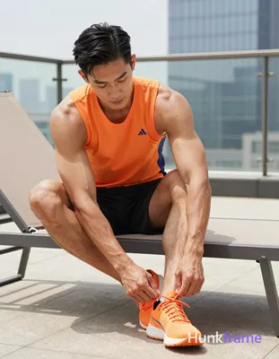 Asian man with medium-tan skin and short black straight side-parted hair, clean-shaven face; Seated 
