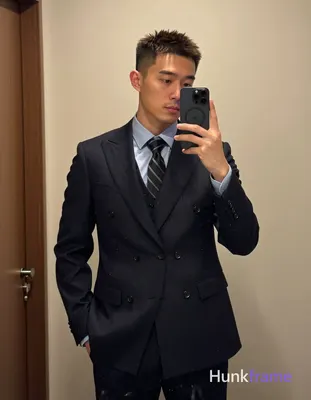 Asian man with short textured dark brown crop hair and clean-shaven face capture