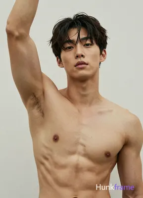 Asian man, light to medium tan skin, short dark brown/black hair slightly tousled on top with bangs 
