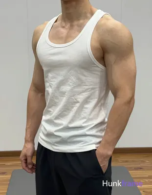 Vertical athletic photography portrait of an adult man with a highly muscular bu