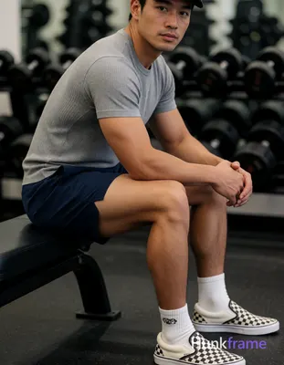 Asian man with light to medium tan skin and short dark hair under a cap, clean-s