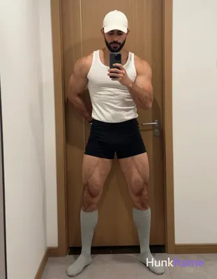 Full-body mirror selfie of an adult man with light-medium skin and short dark ha
