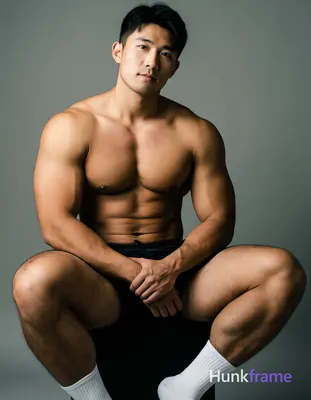 Photorealistic portrait of a shirtless man seated with his torso slightly turned towards the camera,