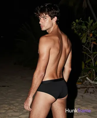 an anonymous figure man with light tan skin sheen, short dark brown tousled hair and side-swept bang