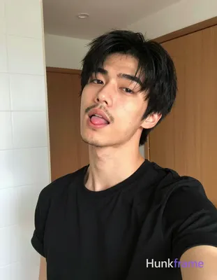 an anonymous figure man with short black hair and upward texture, sparse mustache and chin stubble,