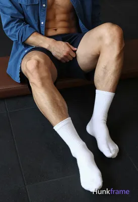 Seated adult man with light to medium tan skin and thick thighs, defined quadriceps and hamstrings; 