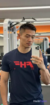 Asian man with medium-tan skin and a short buzz cut, dark brown/black textured f