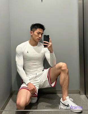 Asian man with light-medium skin and short black textured spiky hair, clean-shaven face in mirror se