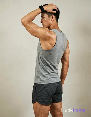 A handsome masculine man in a premium fashion editorial, standing in profile wit