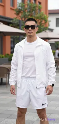 Asian man with short black buzz cut and rectangular thin black framed sunglasses