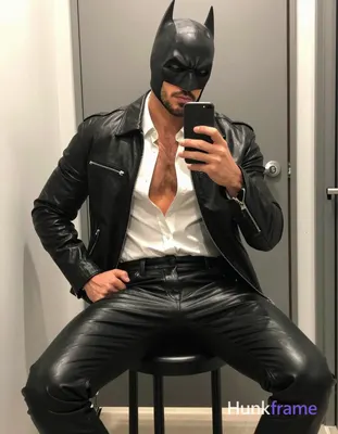 A handsome masculine man in a premium fashion editorial mirror selfie composition, seated fully clot