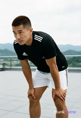 Asian man with short buzz cut and matte dark brown hair, clean-shaven face, neutral focused gaze. St