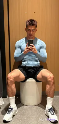Asian man with light to medium tan skin and short dark brown hair featuring textured top and faded s