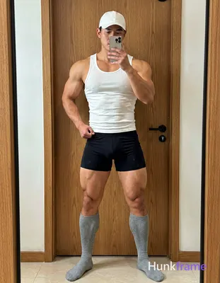 Candid iPhone selfie of a handsome muscular man with light-medium skin and short dark hair under a w