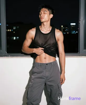 Asian man with light medium tan skin sheen and black short textured crop hair, clean-shaven face ser
