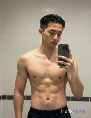 Asian man with light medium tan skin wet sheen, black short slicked back hair receding at temples, c