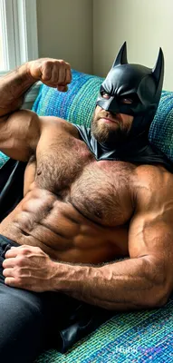 A big hairy stocky masculine man reclining on back with bear energy. He is shirt