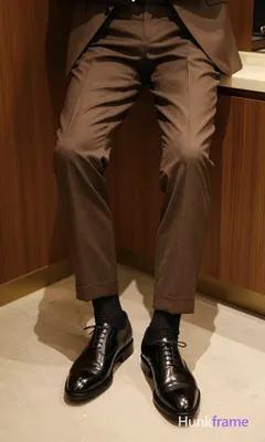 Close-up on lower legs and shoes, centered composition cropped from mid-thighs down to feet. Adult m