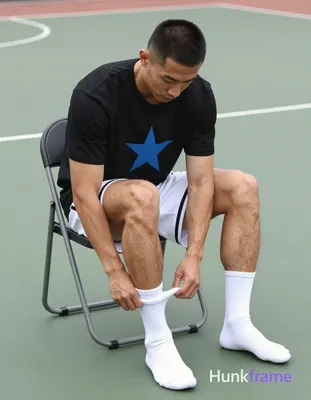 an anonymous figure athlete with light to medium tan skin and short black buzz cut sits on a folding