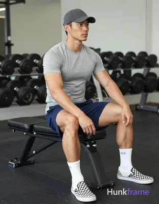 Asian man with light to medium tan skin and short dark hair under a cap, clean-s
