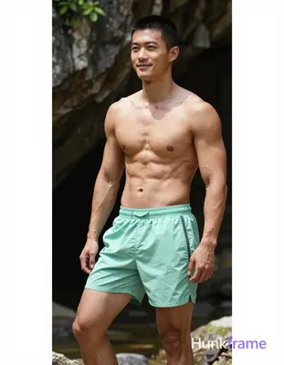 Asian man with light tan skin and short black buzz cut stands in relaxed contrap