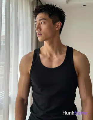 Asian man with medium-tan skin and short textured black hair, standing casually in a home setting ne