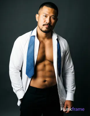 Asian man with medium-tan skin and short black buzz cut, goatee with mustache an