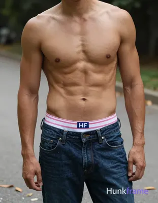 Confident adult man standing shirtless with torso angled slightly right, left ar
