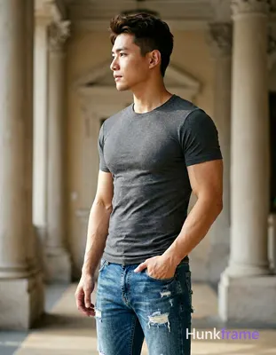 A handsome adult man with light-medium skin and dark brown/black short hair styled upward stands in