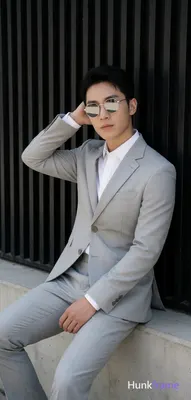 Asian man in a light gray suit jacket, notched lapel, single-button closure with