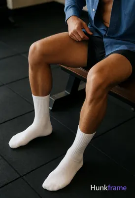 Seated adult man with light to medium tan skin and thick thighs, defined quadriceps and hamstrings; 