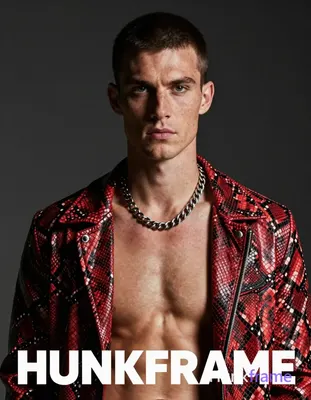 A white man with fair freckled skin and short dark cropped hair faces the camera