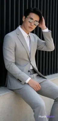 Asian man in a light gray suit jacket, notched lapel, single-button closure with