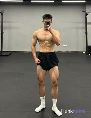 Asian man with light-medium skin and black short textured crop hair, clean-shaven jawline standing i