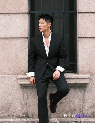 Asian man, short black textured hair spiky on top tapered sides clean-shaven neutral contemplative g