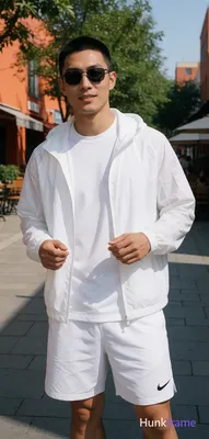 Asian man with short black buzz cut and clean-shaven face, wearing dark rectangu