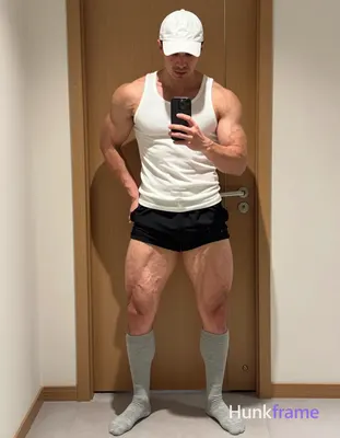 Full-body vertical shot of a muscular man with light-medium skin and short dark 
