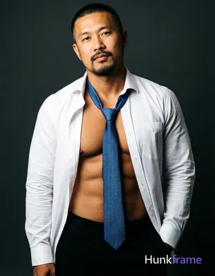 Asian man with medium-tan skin and short black buzz cut, goatee with mustache an
