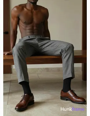Seated male subject, legs extended resting on a low wooden table with left leg s