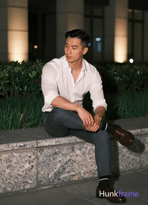 Asian man with short black straight side-parted hair and clean-shaven face, ligh