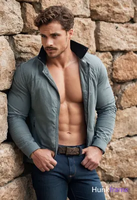 Handsome athletic man with curly brown hair, blue eyes, light skin, short beard 