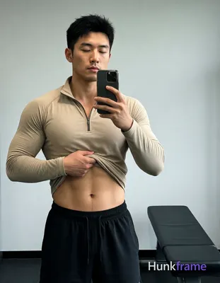 Asian man with light-medium skin and short black textured hair stands facing a m