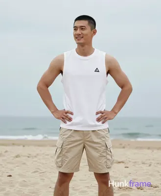 Asian man with short black buzz cut and clean-shaven face, smiling relaxedly while gazing slightly o