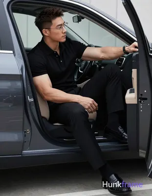 Asian man with short textured dark brown crop hair and side parting, wearing thin metal rimmed glass