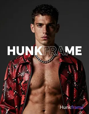 A white man with fair freckled skin and short dark cropped hair faces the camera